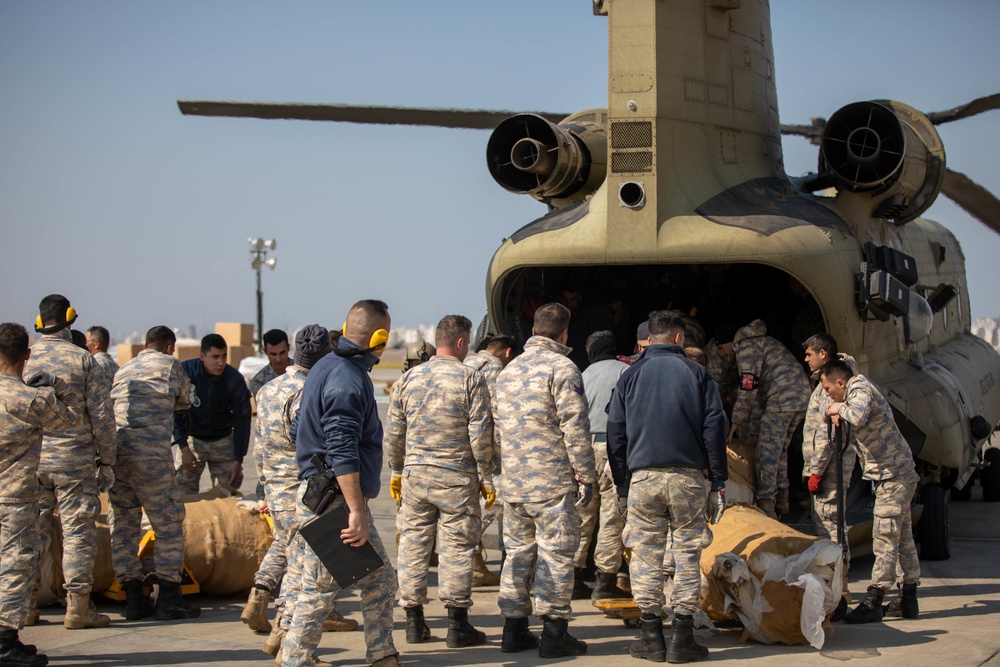 A US Army CH-47 Chinook is loaded with humanitarian aid supplies