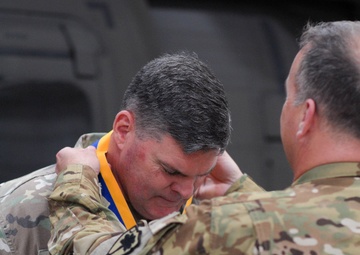 Chief Warrant Officer 5 Matthew Fitter receives the Order of Saint Michael