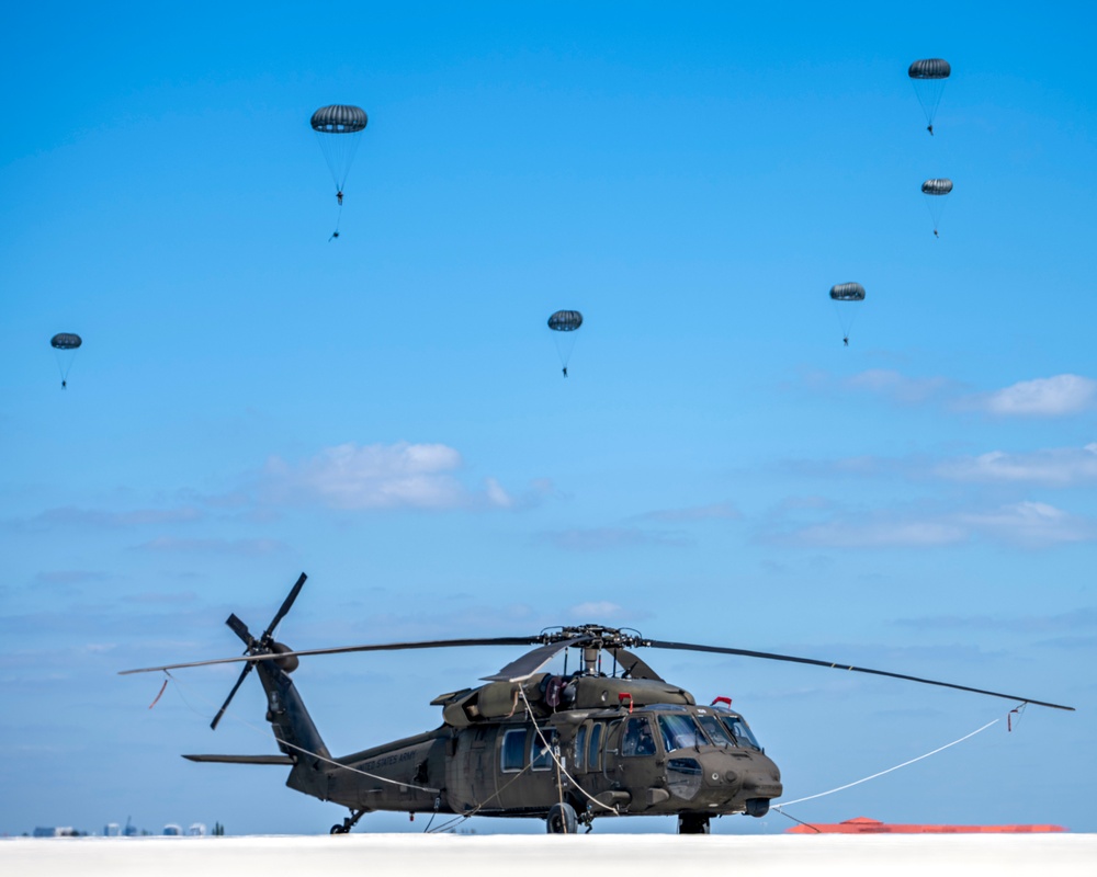 Joint special operations forces preform free falls over Blackhawk unit