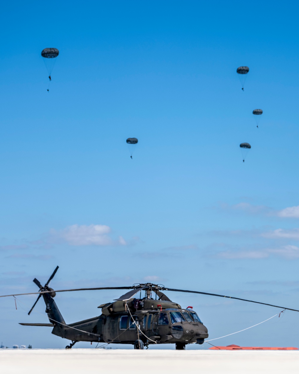 Joint special operations forces preform free falls over Blackhawk unit