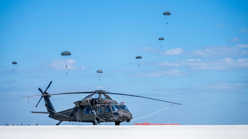 Joint special operations forces preform free falls over Blackhawk unit