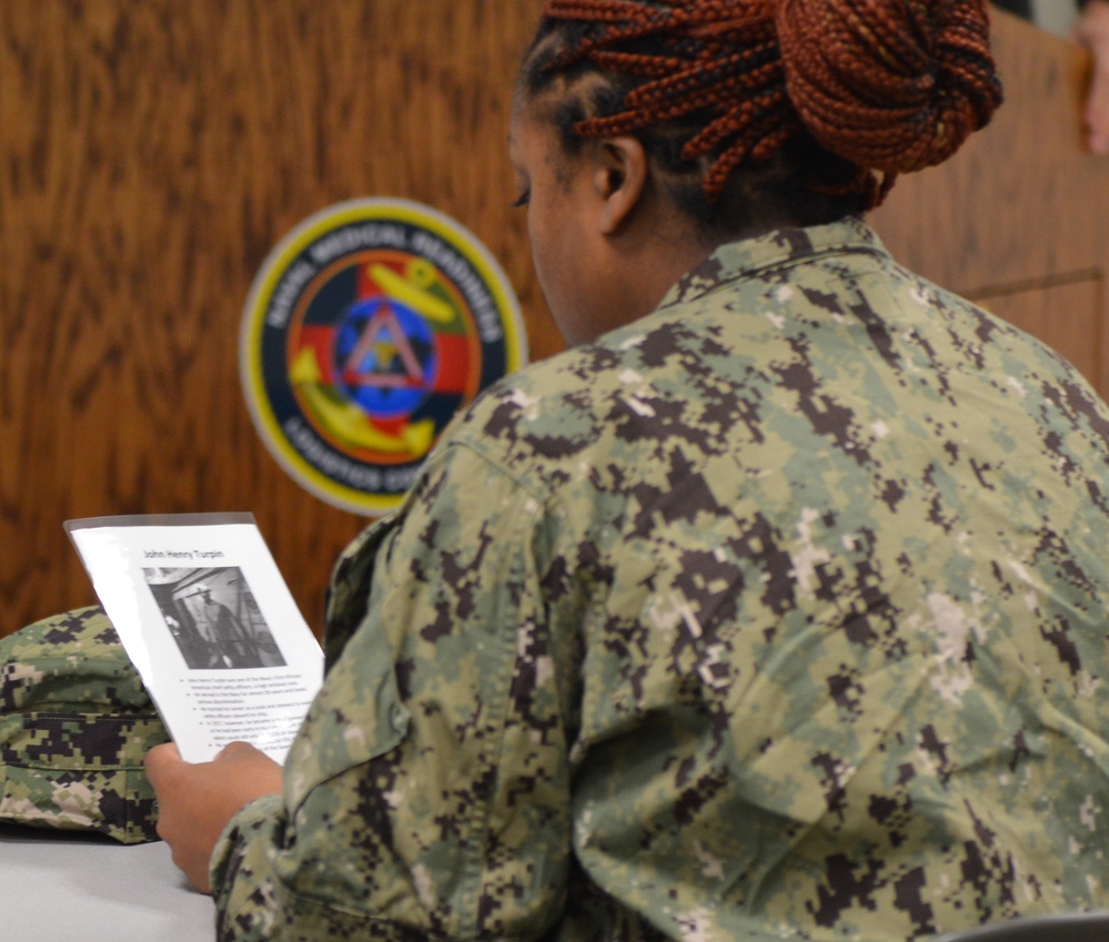 Sailors from Naval Medical Readiness Logistics Command receive a history presentation as part of African American History Month