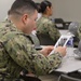 Sailors from Naval Medical Readiness Logistics Command receive a history presentation as part of African American History Month