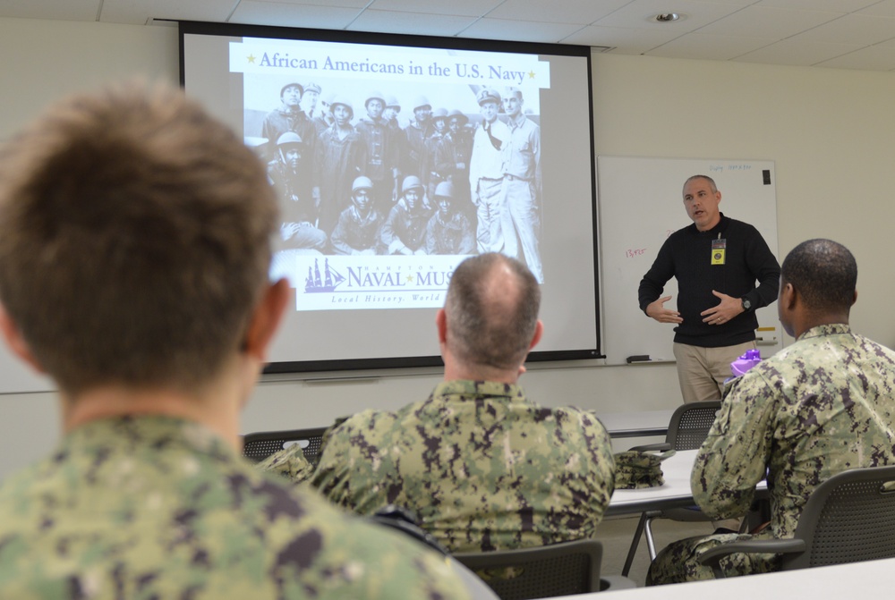 Sailors from Naval Medical Readiness Logistics Command receive a history presentation as part of African American History Month