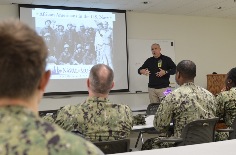 Sailors from Naval Medical Readiness Logistics Command receive a history presentation as part of African American History Month