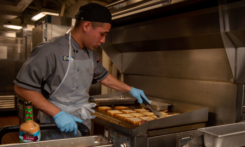 USS Carl Vinson (CVN70) sailor makes dinner in Wardroom 3