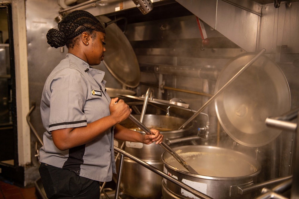 USS Carl Vinson (CVN70) sailor makes dinner in Wardroom 3