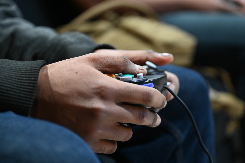 Ellsworth airmen play Super Smash Bros. with controller for Wintervention