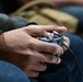 Ellsworth airmen play Super Smash Bros. with controller for Wintervention