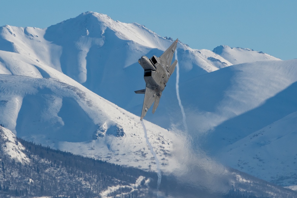 F-22 Raptors ascend above Alaska