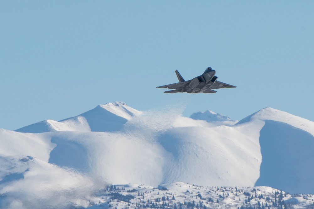 F-22 Raptors ascend above Alaska