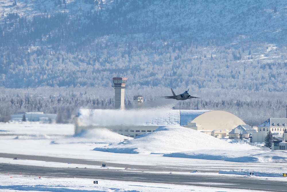 F-22 Raptors ascend above Alaska