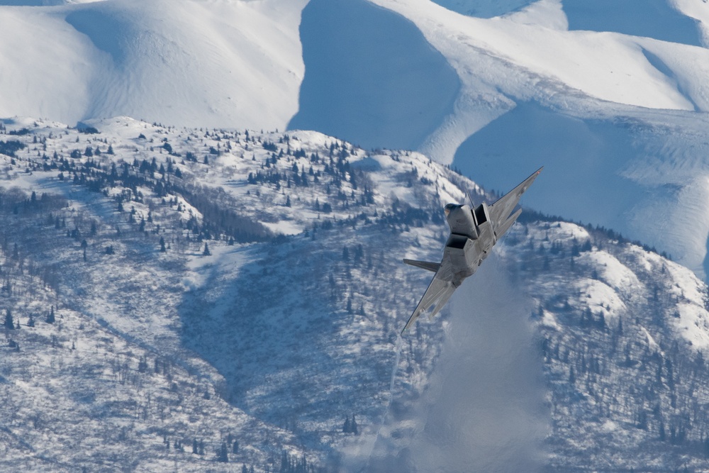 F-22 Raptors ascend above Alaska