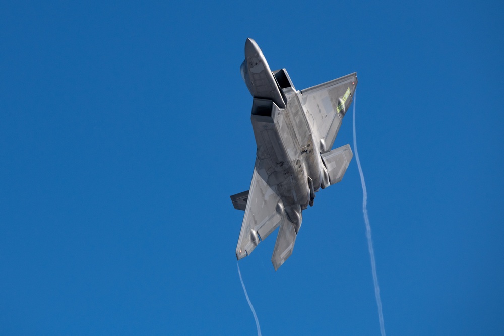 F-22 Raptors ascend above Alaska