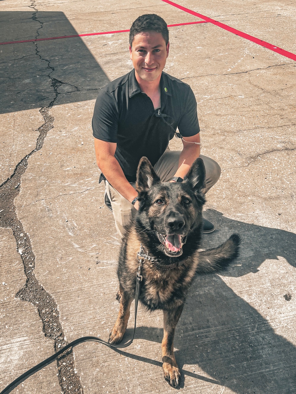 Army Explosive Ordnance Disposal officer bonds with Navy working dog on battlefield