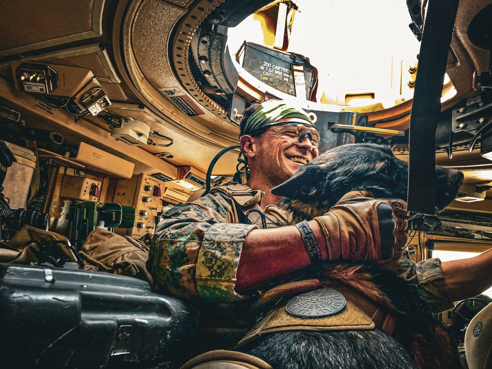 Army Explosive Ordnance Disposal officer bonds with Navy working dog on battlefield