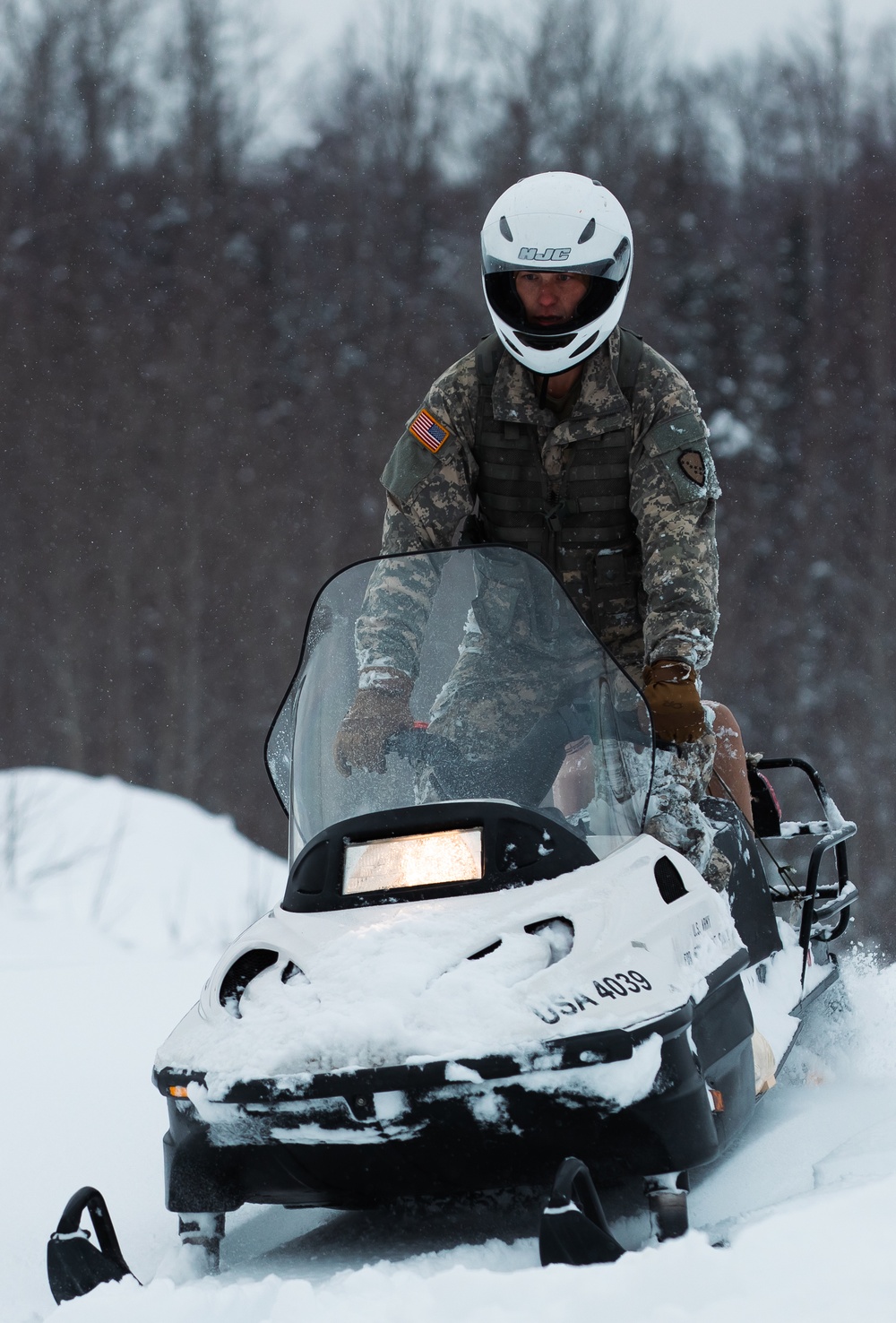 Arctic Warriors Riding Snow Machines