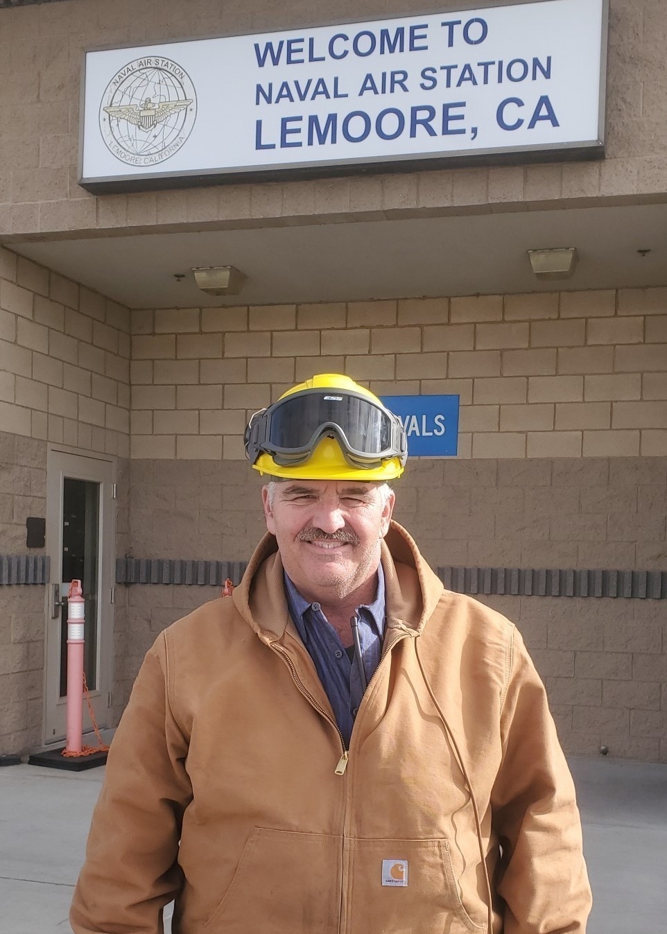 Stephen Beaton, NAVSUP FLC San Diego site Lemoore, stands proudly in front of the Naval Air Station Lemoore headquarters, in Lemoore, Calif., on Feb. 14.