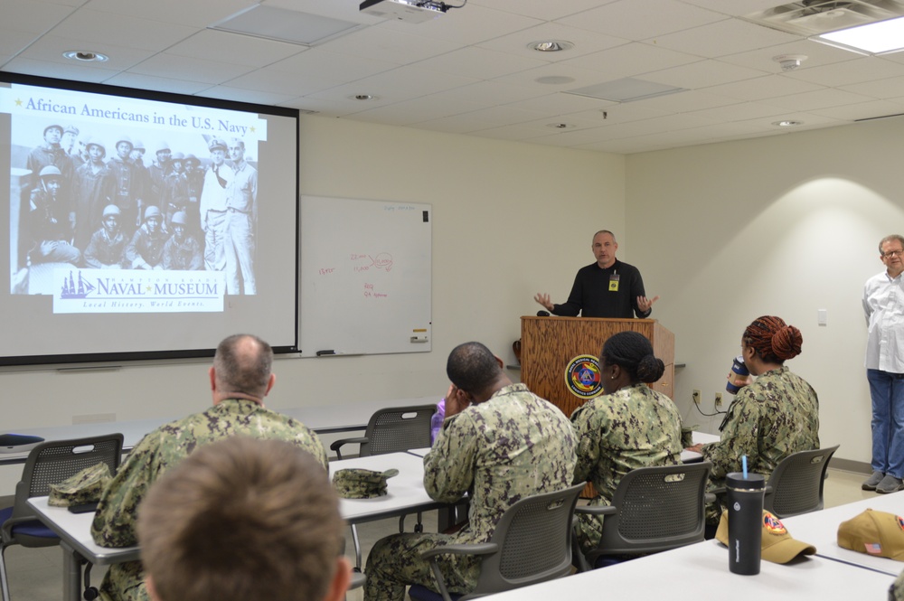 Naval Medical Readiness Logistics Command Sailors and Civilians receive a history presentation from Hampton Roads Naval Museum as part of African American History Month