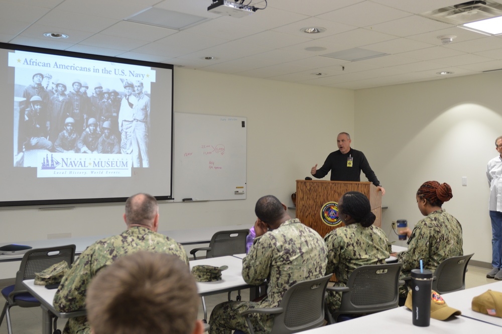 Naval Medical Readiness Logistics Command Sailors and Civilians receive a history presentation from Hampton Roads Naval Museum as part of African American History Month