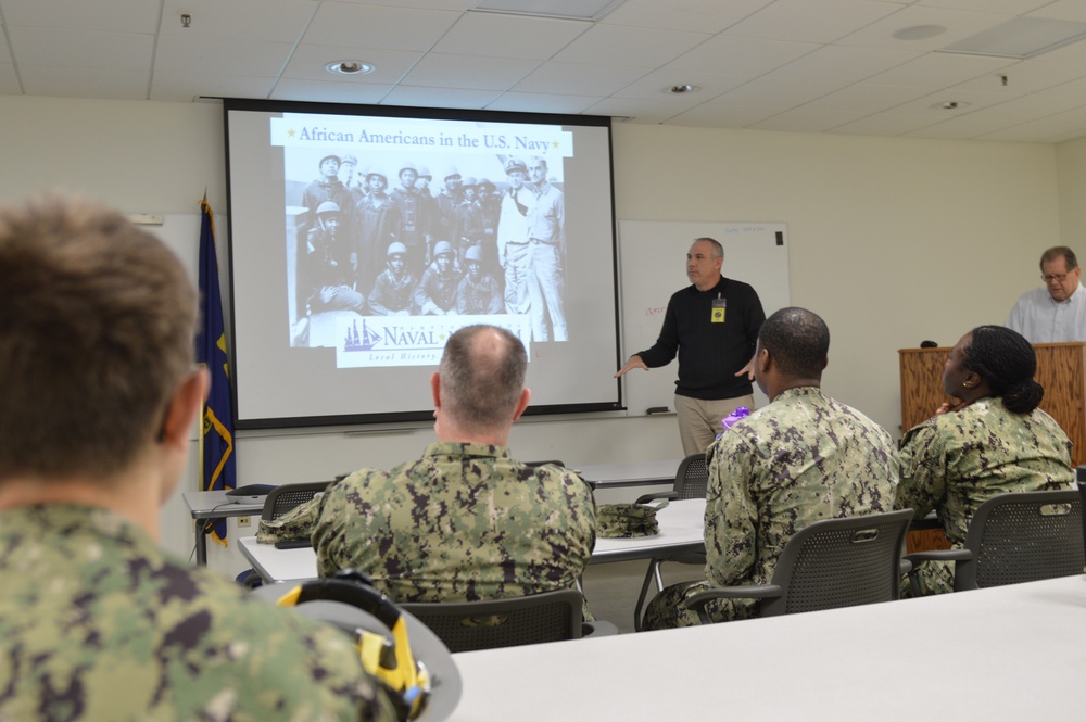 Naval Medical Readiness Logistics Command Sailors and Civilians receive a history presentation from Hampton Roads Naval Museum as part of African American History Month