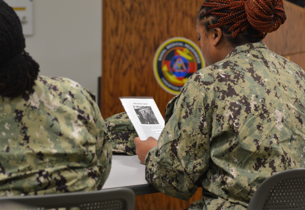 Naval Medical Readiness Logistics Command Sailors and Civilians receive a history presentation from Hampton Roads Naval Museum as part of African American History Month