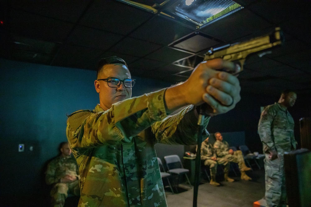 Sgt. Denzel Torres fires a M9 simulation pistol