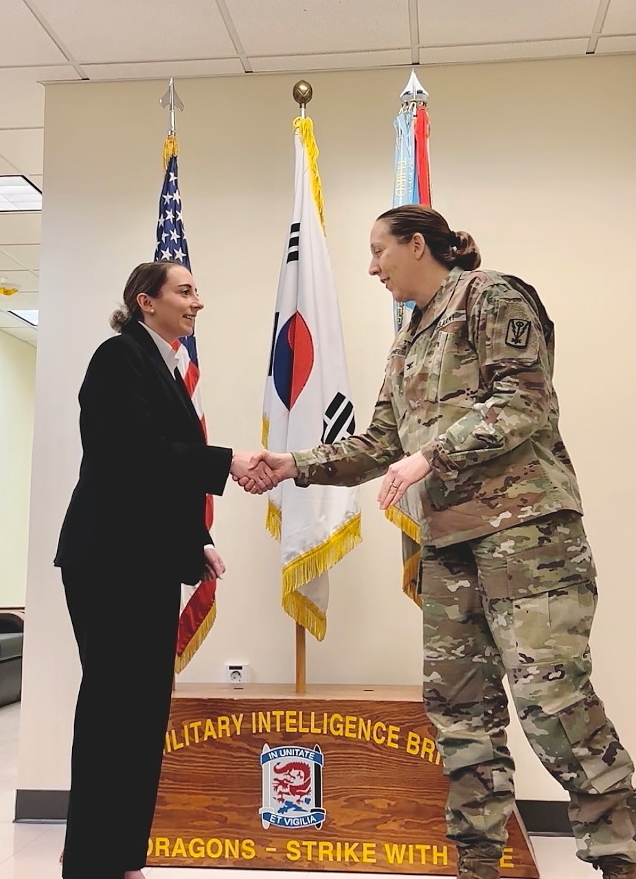 Department of the Army Civilian in Military Intelligence Brigade commissions as a Navy Officer