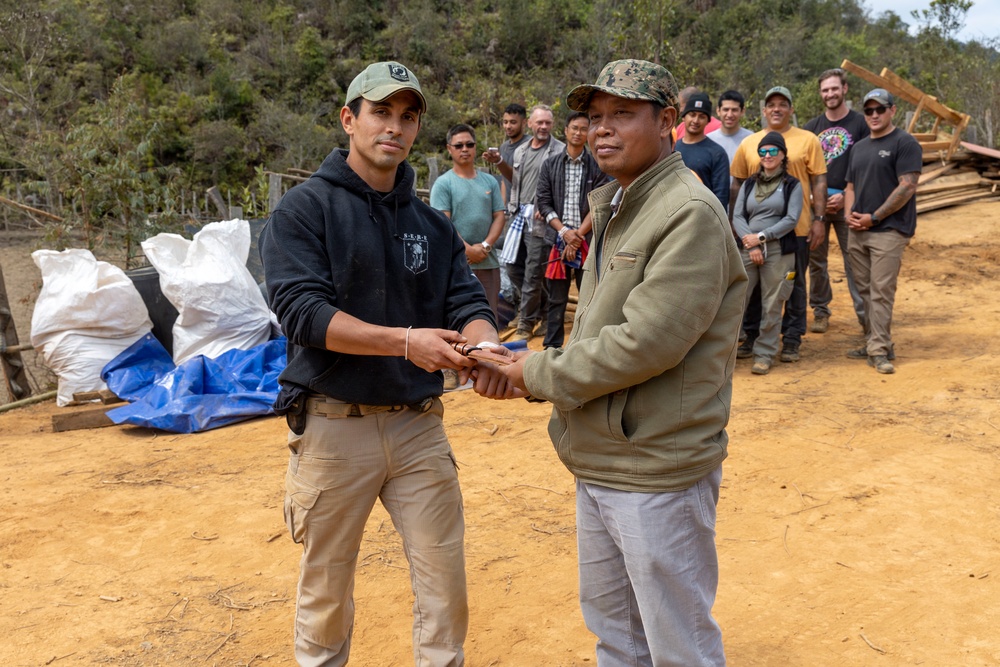 Recovery Team celebrate end of mission with local workers in Laos