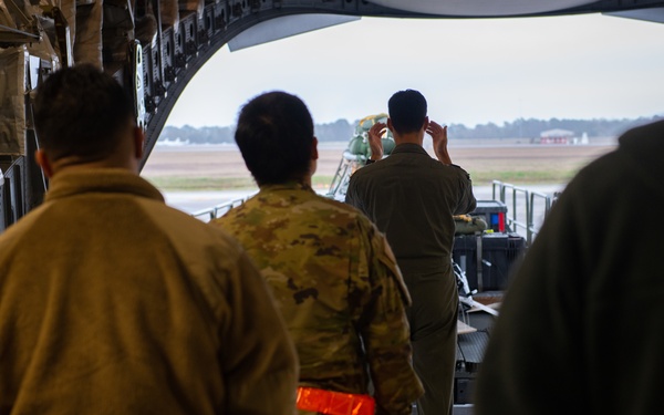 NASA alert crew, JB Charleston Airmen load rescue equipment onto C-17