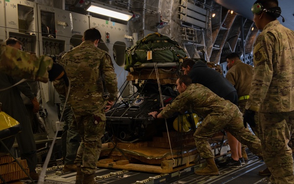 NASA alert crew, JB Charleston Airmen load rescue equipment onto C-17