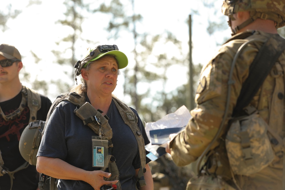 Soldiers with 2BCT of the 10th Mountain Division interact with role players serving as internally displaced people as part of the JRTC