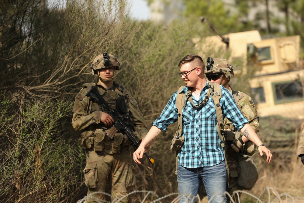 Soldiers with 2BCT of the 10th Mountain Division interact with role players serving as internally displaced people as part of the JRTC