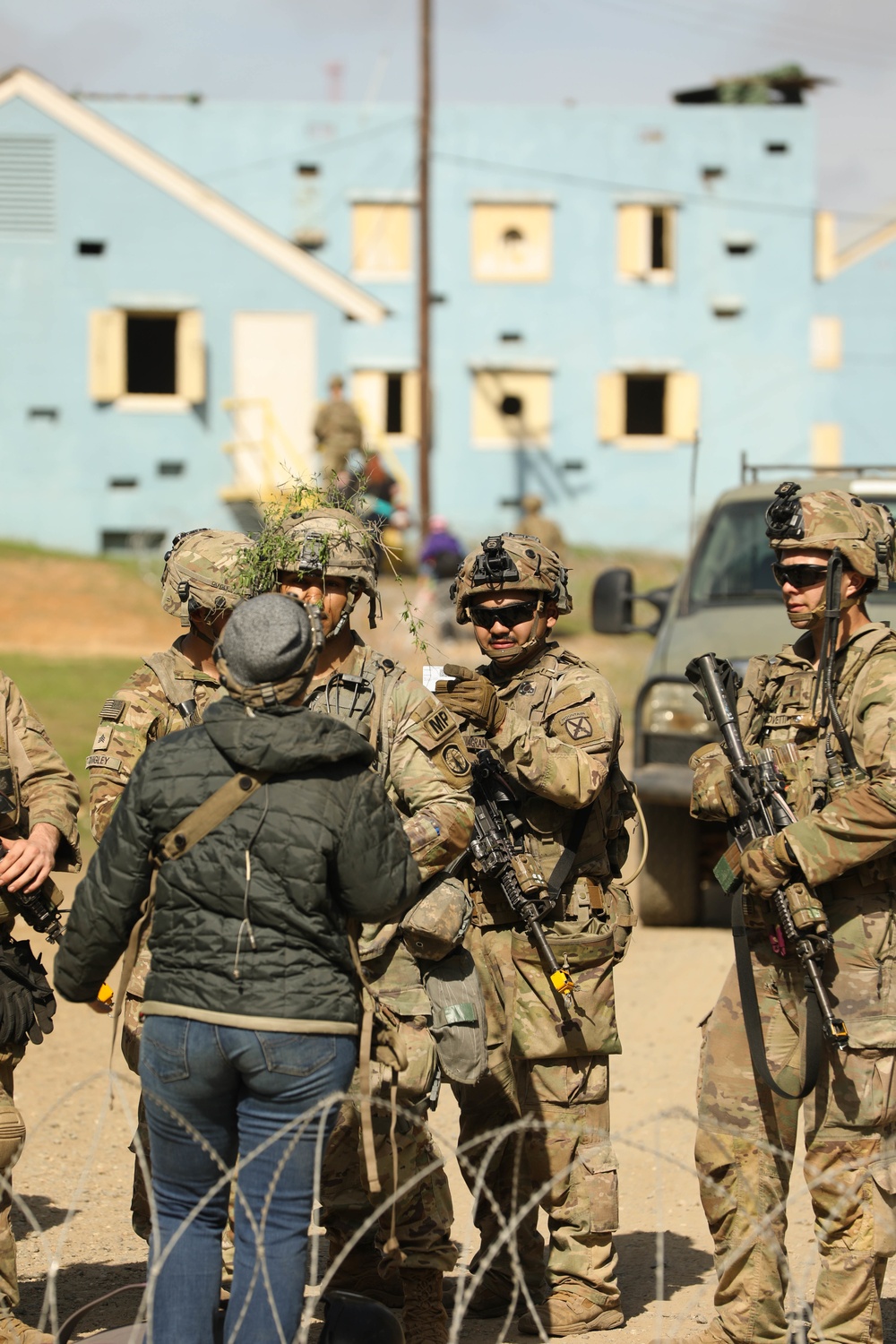 Soldiers with 2BCT of the 10th Mountain Division interact with role players serving as internally displaced people as part of the JRTC