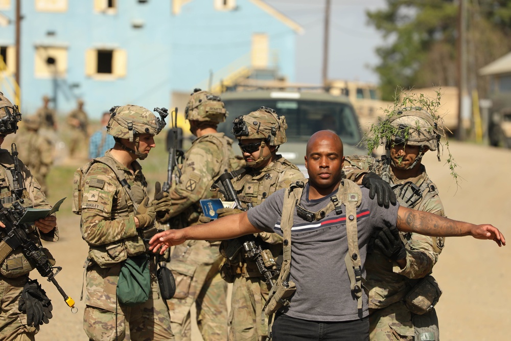 Soldiers with 2BCT of the 10th Mountain Division interact with role players serving as internally displaced people as part of the JRTC