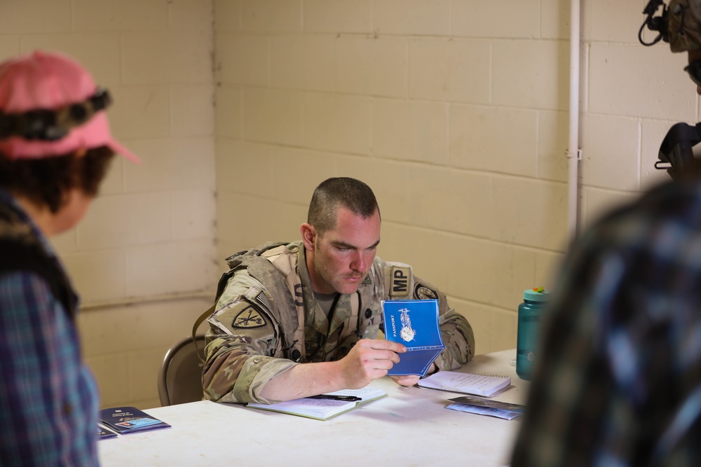 Soldiers with 2BCT of the 10th Mountain Division interact with role players serving as internally displaced people as part of the JRTC