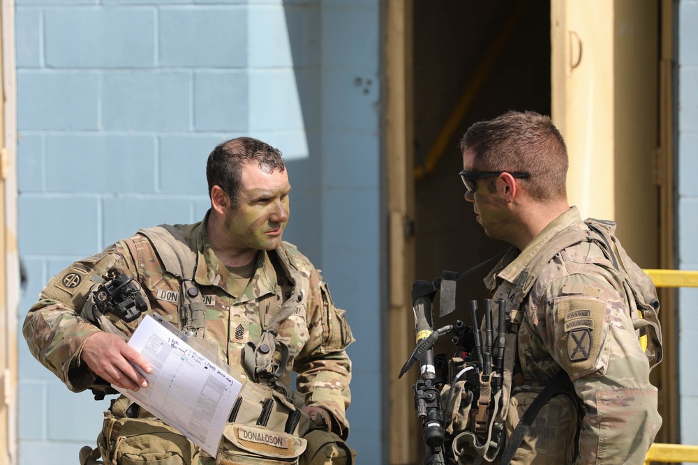 Soldiers with 2BCT of the 10th Mountain Division interact with role players serving as internally displaced people as part of the JRTC