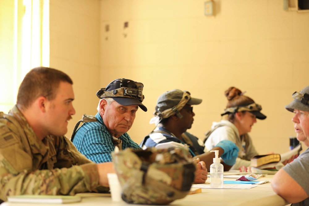 Soldiers with 2BCT of the 10th Mountain Division interact with role players serving as internally displaced people as part of the JRTC