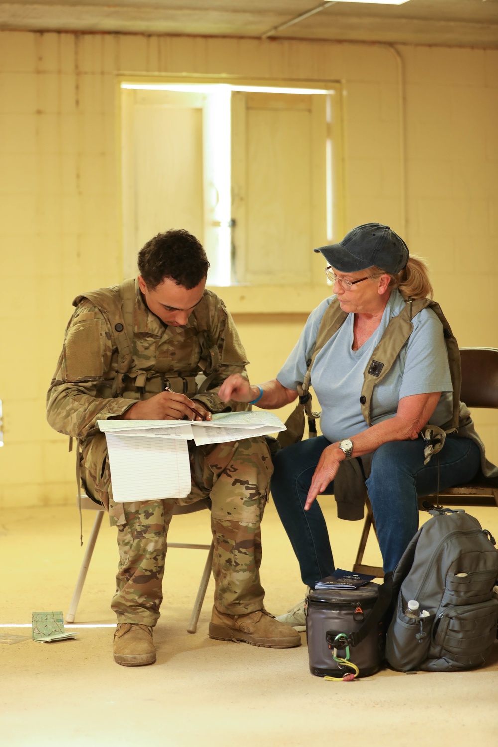 Soldiers with 2BCT of the 10th Mountain Division interact with role players serving as internally displaced people as part of the JRTC