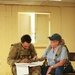 Soldiers with 2BCT of the 10th Mountain Division interact with role players serving as internally displaced people as part of the JRTC