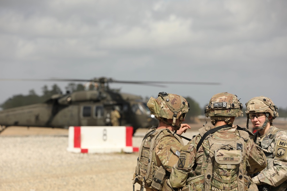 Soldiers with 2BCT of the 10th Mountain Division interact with role players serving as internally displaced people as part of the JRTC