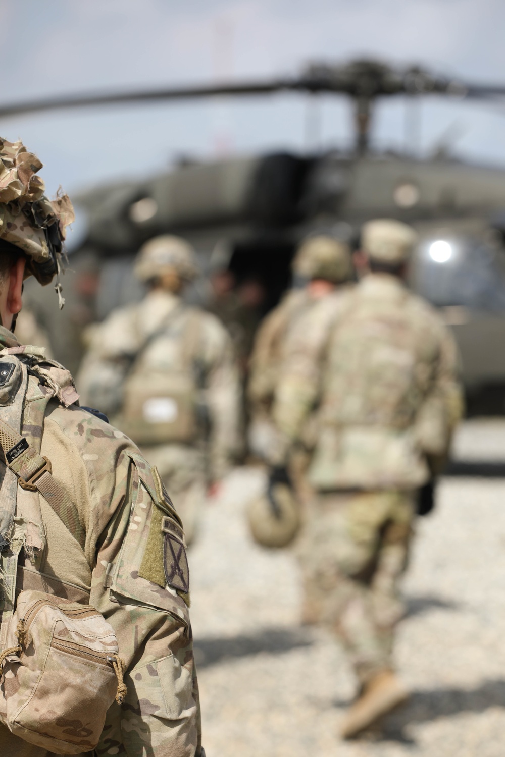 Soldiers with 2BCT of the 10th Mountain Division interact with role players serving as internally displaced people as part of the JRTC