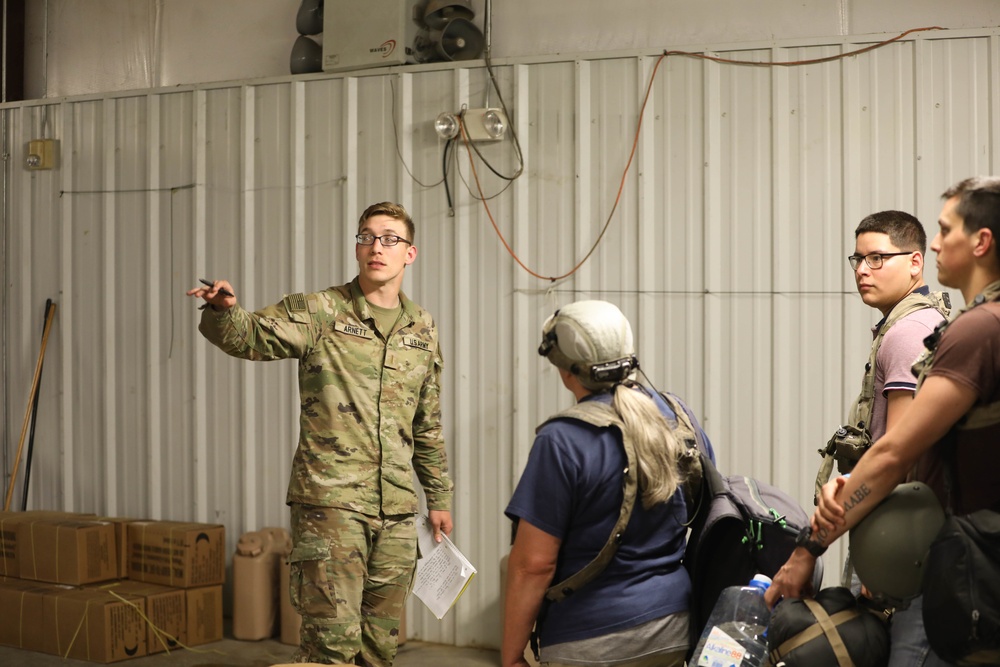 Soldiers with 2BCT of the 10th Mountain Division interact with role players serving as internally displaced people as part of the JRTC