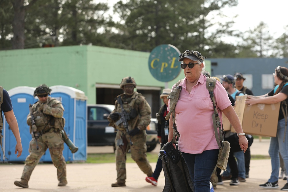 Soldiers with 2BCT of the 10th Mountain Division interact with role players serving as internally displaced people as part of the JRTC