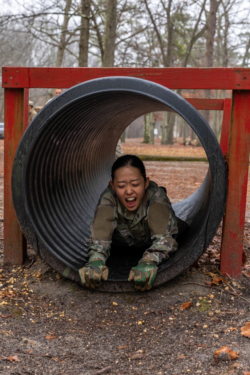 Sgt. Christine Won slides through an obstacle
