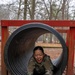 Sgt. Christine Won slides through an obstacle