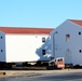 Contractors prepare World War II-era barracks buildings to be moved at Fort McCoy