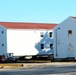 Contractors prepare World War II-era barracks buildings to be moved at Fort McCoy