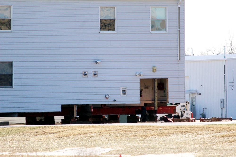 Contractors prepare World War II-era barracks buildings to be moved at Fort McCoy