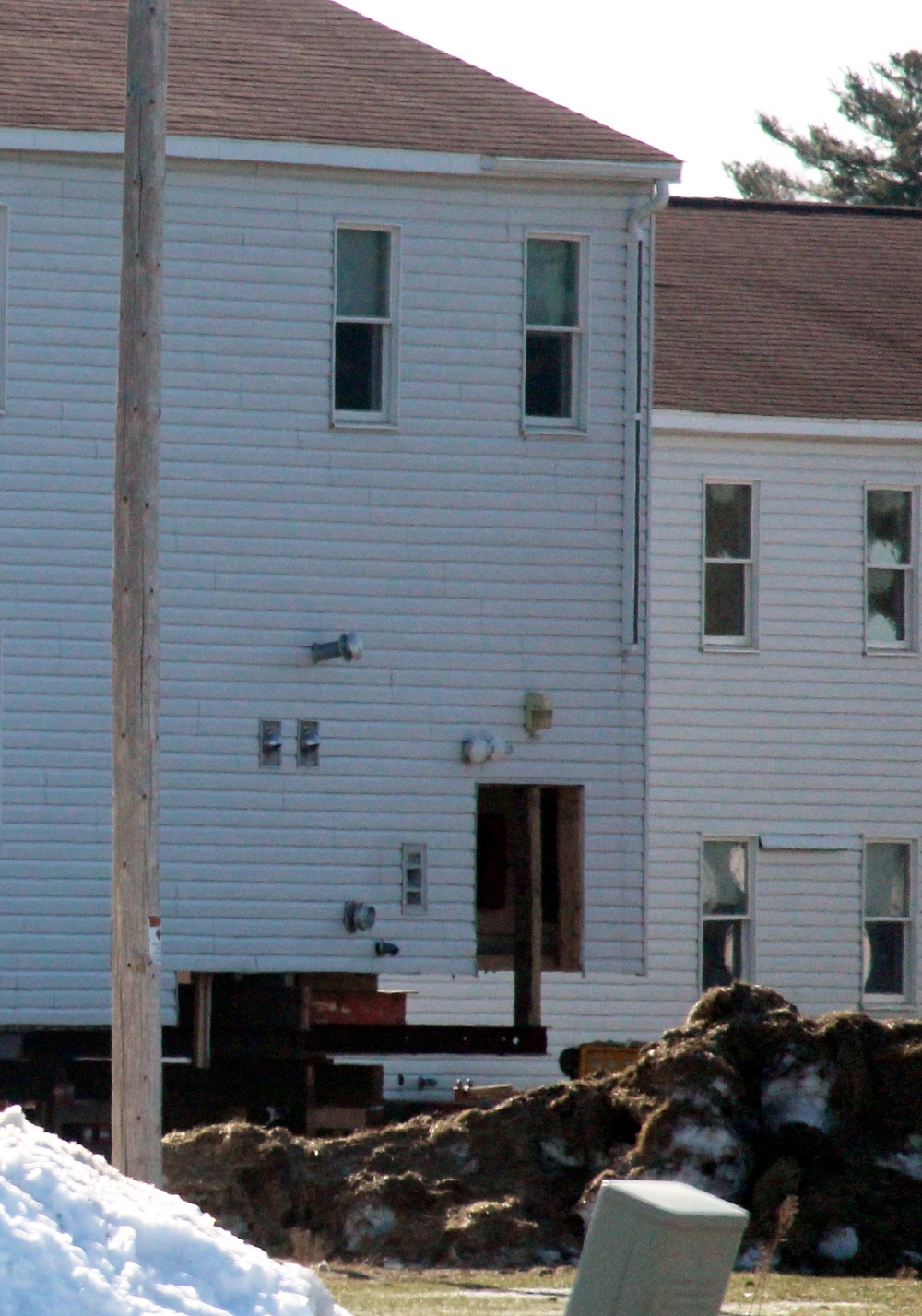 Contractors prepare World War II-era barracks buildings to be moved at Fort McCoy